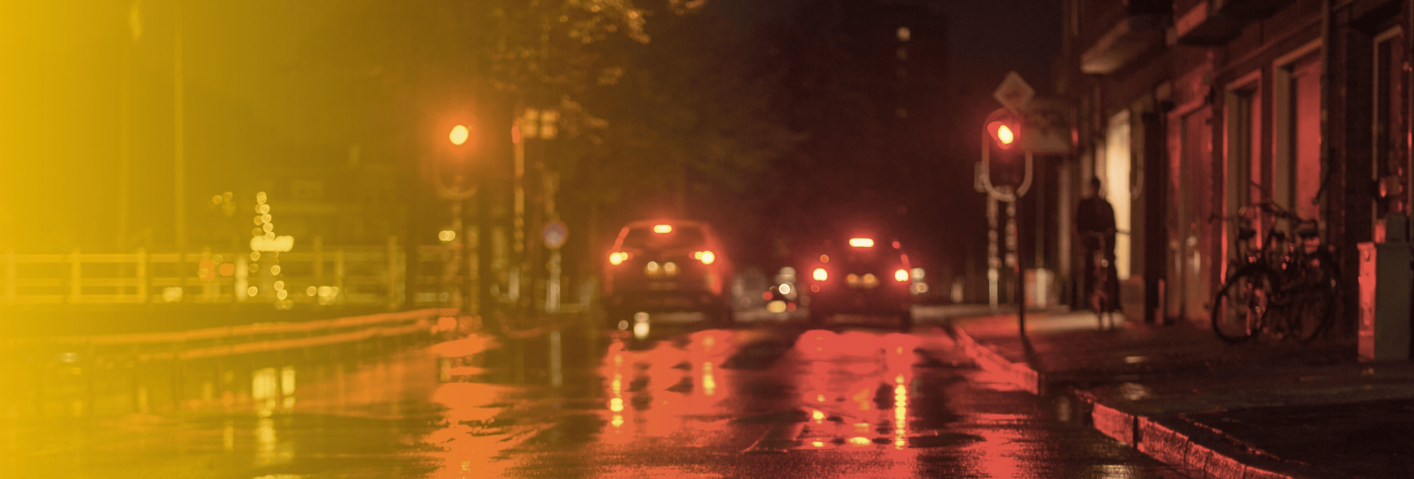 Wet intersection with red lights at night
